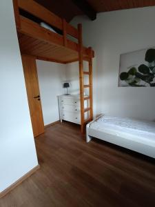 a bedroom with a bunk bed and a dresser at Ferienhaus Morgenrot in Waldbrunn +11 photos