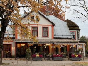 a house with flowers in front of it at City Center Kaķis B&B in Sigulda