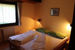 two twin beds in a bedroom with a window at Ferienhaus Sonnenpfad in Waldbrunn +12 photos