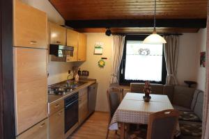 a small kitchen with a table and a dining room at Ferienhaus Sonnenpfad in Waldbrunn