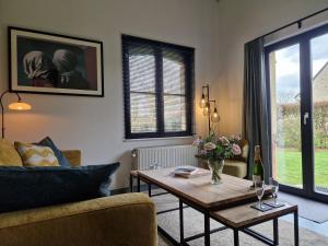 a living room with a table and a couch at Casa René in Aalter