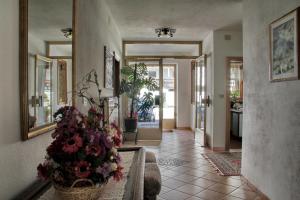 a living room with a vase of flowers on the floor at Garni Villa Linda in Corvara in Badia