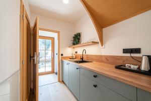 a kitchen with a sink and a wooden counter top at Hamr Divci Kamen in Křemže