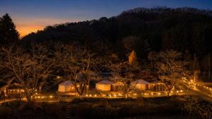 a group of tents with lights at night at みどりの村 in Ogano