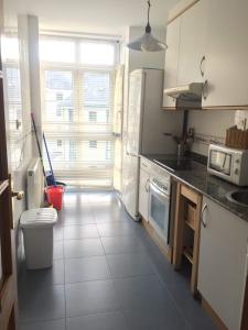 a kitchen with a sink and a toilet in it at Apartamentos Ria de Foz in Foz