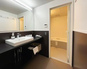 a bathroom with a sink and a mirror at Lapis Jogasaki B&B in Ito +80 photos