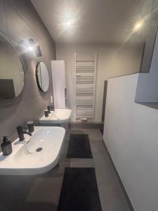 a bathroom with a sink and two mirrors at Zentrale City Apartments in Oldenburg +43 photos