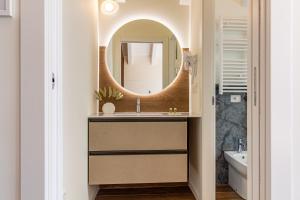 a bathroom with a sink and a mirror at Nobel Flower Apartments in Lissone
