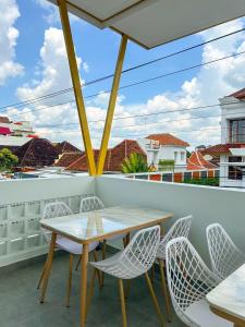 a table and chairs on a balcony with a view at At Paviliun With Private Pool in Timuran