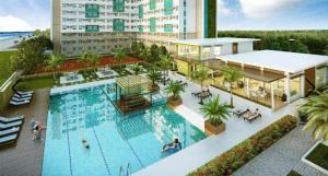 an overhead view of a swimming pool at a hotel at Bayview Haven Studio at Marina Spatial Condominium in Piapi