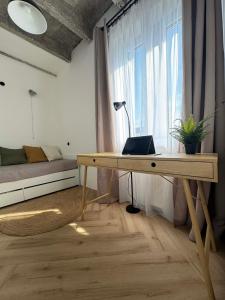 a room with a desk and a bed and a window at Old Town, The Reward apartment with terrace with a view in Staré Mesto