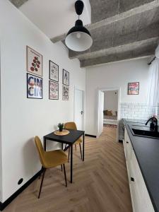 a kitchen and dining room with a table and chairs at Old Town, The Reward apartment with terrace with a view in Staré Mesto