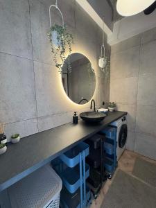 a bathroom with a sink and a mirror at Old Town, The Reward apartment with terrace with a view in Staré Mesto +22 photos