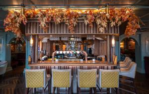 a bar in a pub with chairs around it at The Great Northern Hotel in Bundoran +13 photos