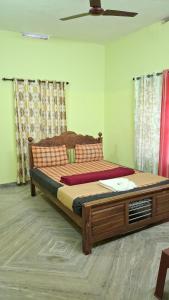 a bedroom with a large bed with a wooden frame at Golden cypress resort with pool in Vythiri