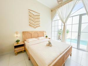a bedroom with a large bed and a large window at At Paviliun With Private Pool in Timuran +18 photos