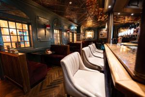 a bar with a row of chairs and a counter at The Great Northern Hotel in Bundoran