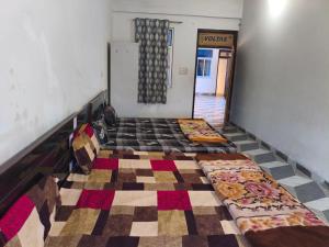 an empty room with two beds on the floor at Ma SAVITRI PALACE in Ayodhya