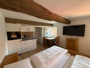 a bedroom with a bed and a kitchen with a table at Hof König in Everswinkel