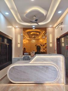 a room with a large tub in the middle at Ma SAVITRI PALACE in Ayodhya