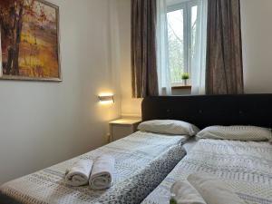 a bedroom with two beds with towels on them at Crystal Lakes Apartment in Plitvička Jezera