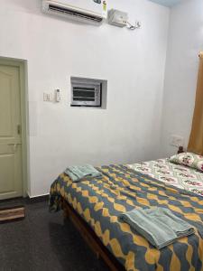 a bedroom with a bed with towels on it at Mannath lands end Beach house in Kaup