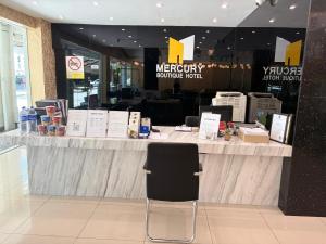 a counter with a chair in front of a store at Mercury Boutique Hotel in Malacca