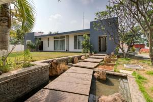 a house with a pond in front of it at Sais lotus villa -Home stay and Event venue in Coimbatore