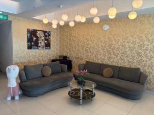 a living room with a couch and a table at Mercury Boutique Hotel in Malacca