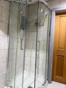 a shower with a glass door in a bathroom at Flat 4 Rylands Street in Warrington