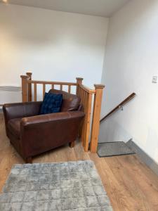 a brown leather couch sitting in a living room at Flat 4 Rylands Street in Warrington