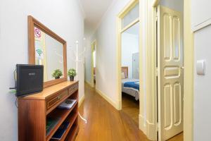 a bedroom with a bed and a dresser with a mirror at Casa Mariana 2 - Sintra, Apartment in Sintra