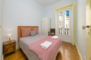 a bedroom with a bed with two towels on it at Casa Mariana 2 - Sintra, Apartment in Sintra