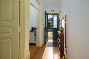 a hallway with a door leading to a room with a kitchen at Casa Mariana 2 - Sintra, Apartment in Sintra