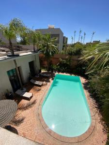 a swimming pool in the middle of a yard at Villa Marrakech ,Piscine Privée & Luxe Authentique in El Aggada
