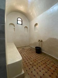 a bathroom with a bench and a tile floor at Villa Marrakech ,Piscine Privée & Luxe Authentique in El Aggada +64 photos
