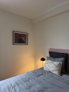 a bedroom with a bed with a picture on the wall at Aqui na Praia do Pedrogão in Leiria