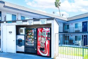 a cocacola soda machine in front of a building at Motel 6-Pleasanton, CA in Pleasanton
