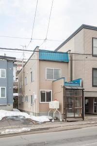 a bus stop on the side of a street at Otaru Retro Villa in Otaru