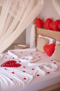 a bed with red hearts on the sheets at Kabak Freedom Deluxe Hotel in Faralya +19 photos