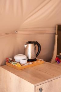 a tea kettle on a wooden tray on a table at Kabak Freedom Deluxe Hotel in Faralya