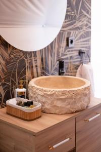 a bathroom with a wooden sink on top of a counter at Kabak Freedom Deluxe Hotel in Faralya