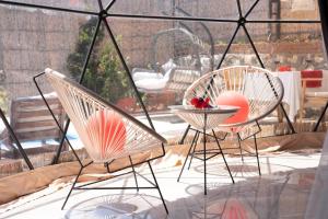 two chairs and a table on a patio at Kabak Freedom Deluxe Hotel in Faralya
