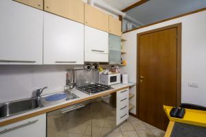 a kitchen with a sink and a microwave on a counter at Gigi House in Verbania +14 photos