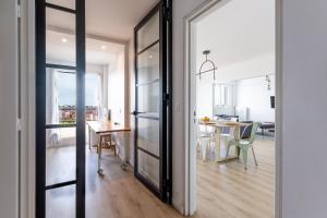 a kitchen and dining room with a sliding glass door at Nouveau - Horizons - Vue mer in Saint-Nazaire