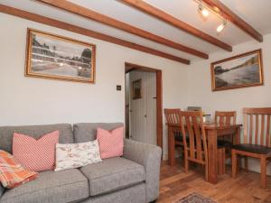 a living room with a couch and a table at Isla cottage in Northallerton