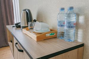 two bottles of water sitting on top of a counter at City Heart Hotel in Tbilisi City