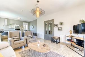 a living room with a couch and a table at Villa Aphrodite in Puigventos