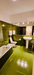a green bathroom with two sinks and two toilets at Renzo in Bellagio +20 photos