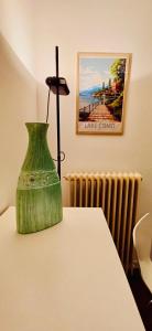 a green vase sitting on top of a table at Renzo in Bellagio
